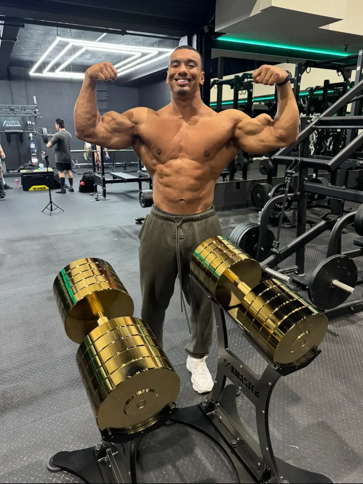 Larry Wheels with the 160kg gold dumbbells.